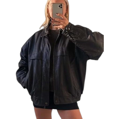 Person wearing a black leather jacket taking a mirror selfie on a white background