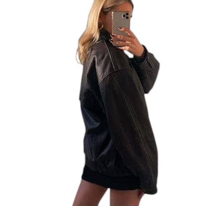 Person wearing a black leather jacket taking a mirror selfie on a white background