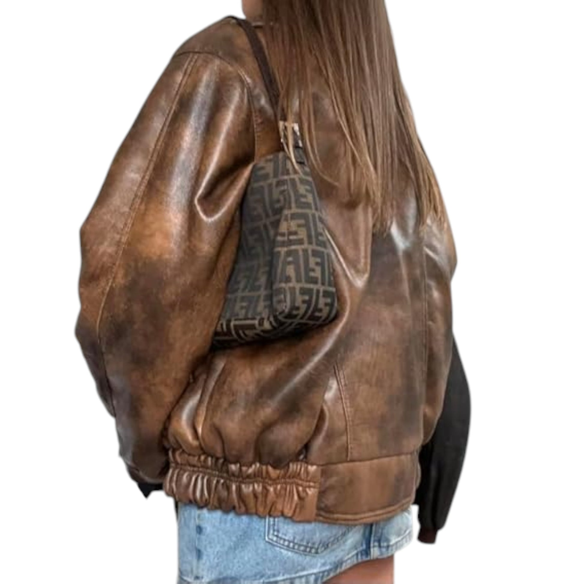 Brown leather jacket worn by a person with a patterned bag.