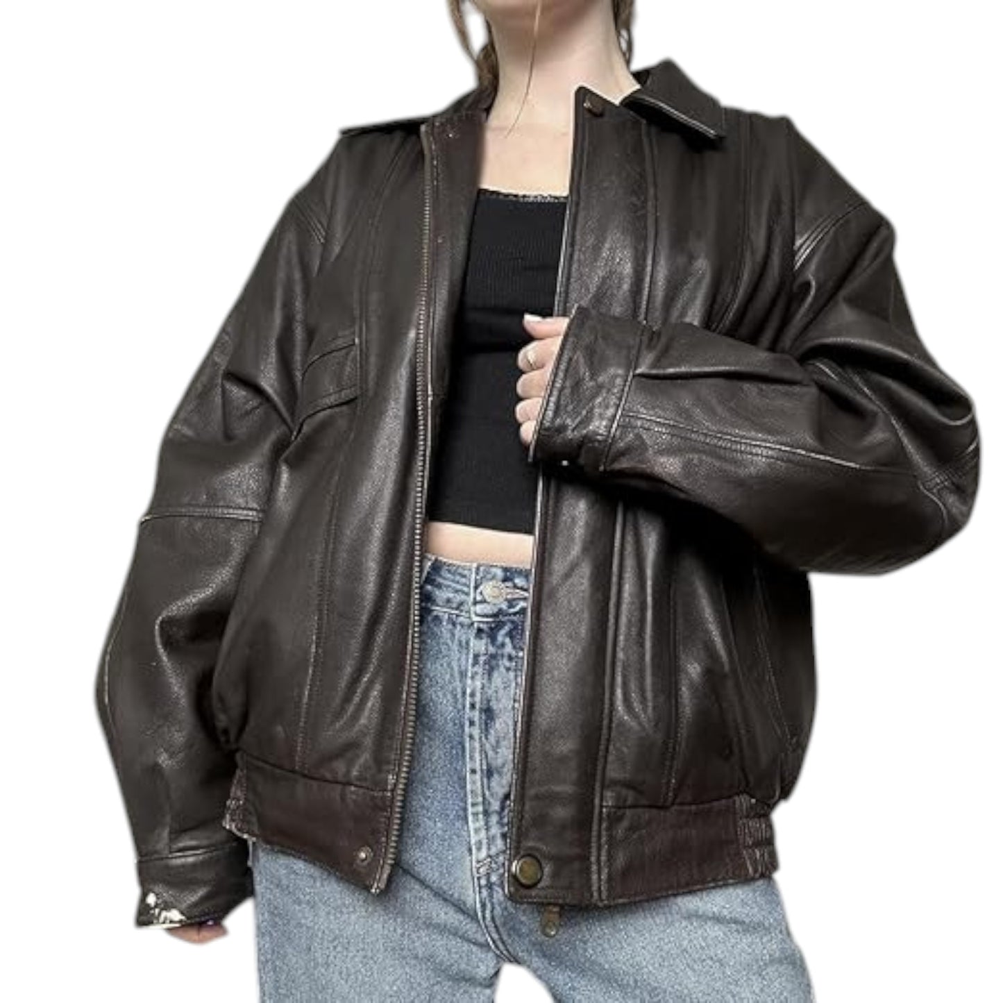 Person wearing a black leather jacket over a black top and blue jeans on a white background
