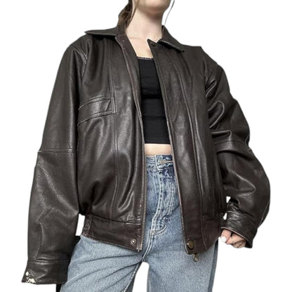 Person wearing a brown leather jacket and blue jeans on a white background