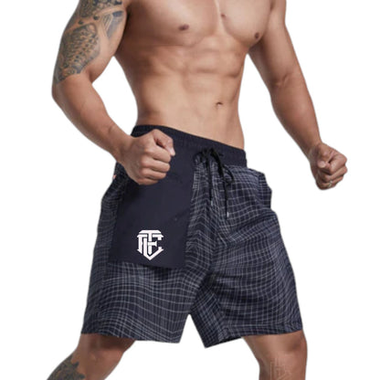Man wearing navy plaid shorts with a logo on a white background