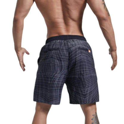 Person wearing navy checkered shorts on a white background