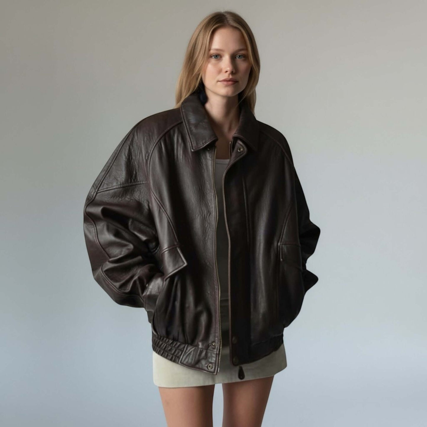 Fit to lead Traders authentic vintage 90s brown leather bomber jacket with ribbed cuffs and hem, worn by a model.