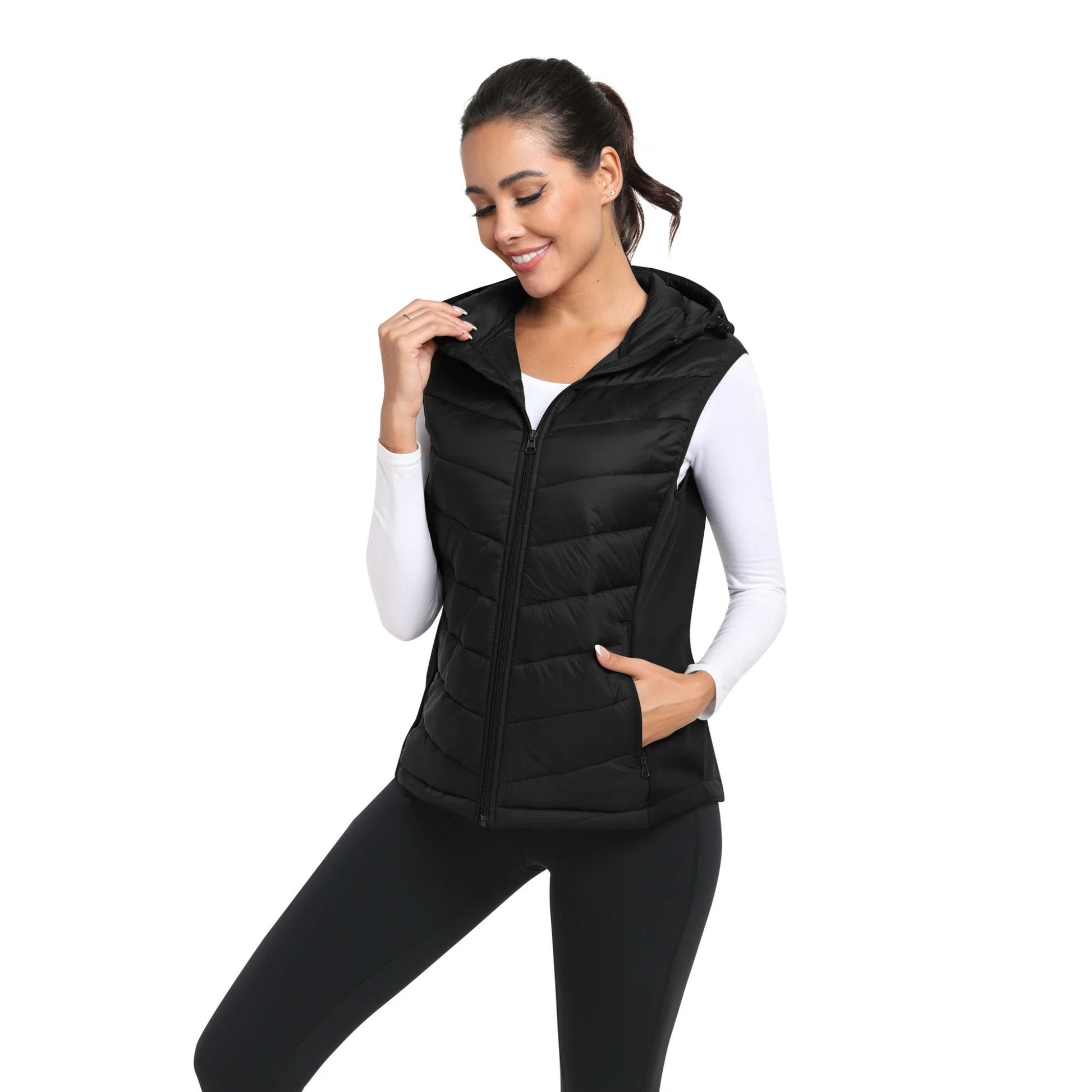 Woman wearing a black puffer vest on a white background