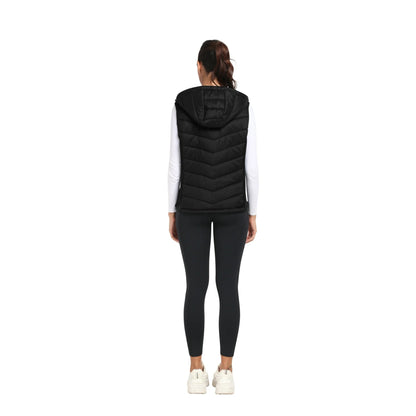 Person wearing a black puffer vest on a white background